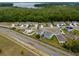 An aerial view of a peaceful neighborhood near a green area, emphasizing the community's close proximity to nature at 3033 Beau Loop, Tavares, FL 32778
