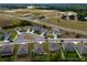 An aerial view of a suburban neighborhood showcasing manicured lawns, tree-lined streets, and convenient access to amenities at 3033 Beau Loop, Tavares, FL 32778