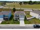 Aerial view of a two-story home with a driveway, fenced backyard, and well-maintained landscaping at 3033 Beau Loop, Tavares, FL 32778