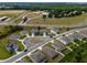 An aerial view of a neighborhood featuring well-maintained homes, landscaping, and community spaces in a desirable location at 3033 Beau Loop, Tavares, FL 32778