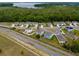 An aerial view of a peaceful neighborhood near a green area, emphasizing the community's close proximity to nature at 3033 Beau Loop, Tavares, FL 32778