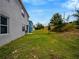 A spacious backyard featuring a well-manicured lawn, providing ample space for outdoor activities at 3033 Beau Loop, Tavares, FL 32778
