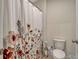 Bathroom with a toilet and floral shower curtain at 3033 Beau Loop, Tavares, FL 32778