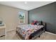 Bedroom with a full-sized bed and a window overlooking the trees at 3033 Beau Loop, Tavares, FL 32778