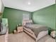 This bedroom features plush carpet, pale trim, and a comfy-looking bed with thick bedding at 3033 Beau Loop, Tavares, FL 32778