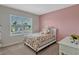 Bedroom with a full-sized bed and a window with a view of the neighborhood at 3033 Beau Loop, Tavares, FL 32778