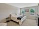 This bedroom has carpet flooring, a television, and windows that provide plenty of natural light at 3033 Beau Loop, Tavares, FL 32778