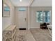 Inviting foyer with tiled floors, a front door with natural light, and access to the carpeted living area at 3033 Beau Loop, Tavares, FL 32778