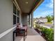 Cozy covered front porch with seating and landscaping, offering a relaxing space to enjoy the neighborhood views at 3033 Beau Loop, Tavares, FL 32778