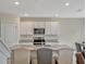 Modern kitchen showcases stainless steel appliances, granite countertops, and a convenient layout for cooking and entertaining at 3033 Beau Loop, Tavares, FL 32778