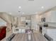 Open-concept kitchen with granite countertops, stainless steel appliances, a center island and eat-in dining space at 3033 Beau Loop, Tavares, FL 32778