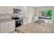 Modern kitchen showcases stainless steel appliances, granite countertops, and a convenient layout for cooking and entertaining at 3033 Beau Loop, Tavares, FL 32778