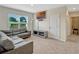Living room with gray sofa, entertainment stand, and view to the yard at 3033 Beau Loop, Tavares, FL 32778
