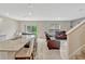 Open concept living area shows a seamless layout of kitchen and seating area, and access to the outdoor living space at 3033 Beau Loop, Tavares, FL 32778