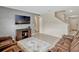 Open living area with media center, leather seating, stairs to second floor and view to entry at 3033 Beau Loop, Tavares, FL 32778