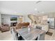 Open-concept living and dining area with tile flooring, stainless appliances and comfortable seating at 3033 Beau Loop, Tavares, FL 32778