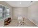 Bright office space featuring natural light from a large window, neutral carpet and a modern desk at 3033 Beau Loop, Tavares, FL 32778