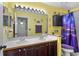 Bright bathroom with double sinks, lots of light, and a purple theme at 3137 Timucua Cir, Orlando, FL 32837