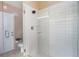 Bathroom featuring a glass enclosed shower with a rainfall showerhead and tiled walls at 3137 Timucua Cir, Orlando, FL 32837