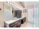 Bright bathroom with double sink vanity, white counters, tile flooring, and walk-in shower at 3137 Timucua Cir, Orlando, FL 32837