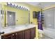 Well-lit bathroom with double sink vanity, large mirror, and a shower-tub combination with storage at 3137 Timucua Cir, Orlando, FL 32837
