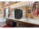 Bright bathroom with a double vanity, and expansive mirror with lights at 3137 Timucua Cir, Orlando, FL 32837