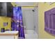 Bright bathroom featuring a shower-tub with a contemporary shower curtain and updated fixtures at 3137 Timucua Cir, Orlando, FL 32837