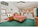 Cozy bedroom featuring floral bedding, decorative accents, and an ensuite bathroom for added convenience at 3137 Timucua Cir, Orlando, FL 32837