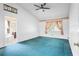 Spacious carpeted bedroom featuring vaulted ceiling, ceiling fan and floral wallpaper accents at 3137 Timucua Cir, Orlando, FL 32837