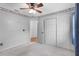 Bedroom with gray carpet, sliding closet doors, Patriots-themed border, and view to another room at 3137 Timucua Cir, Orlando, FL 32837