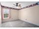 Bright bedroom with a gray carpet, colorful wallpaper border, window, and pink curtains at 3137 Timucua Cir, Orlando, FL 32837