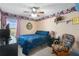 Bedroom with ceiling fan, rocking chair, and blue bedspread at 3137 Timucua Cir, Orlando, FL 32837