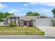 Inviting single-story home featuring a two-car garage and beautifully manicured front yard at 3137 Timucua Cir, Orlando, FL 32837