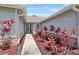 Charming walkway leading to the front door, surrounded by lush landscaping and well-maintained exteriors at 3137 Timucua Cir, Orlando, FL 32837