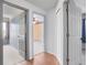 Hallway showing multiple bedrooms with gray carpet, hard wood, and wallpaper borders at 3137 Timucua Cir, Orlando, FL 32837