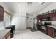 Well-lit kitchen with stainless steel appliances, dark cabinetry, and ample storage, adjacent to closet at 3137 Timucua Cir, Orlando, FL 32837