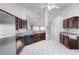 Open concept kitchen with dark cabinets and modern appliances flows into the living area at 3137 Timucua Cir, Orlando, FL 32837