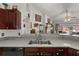 Bright open kitchen with a view to the rear, showcasing countertops, cabinetry and a kitchen bar at 3137 Timucua Cir, Orlando, FL 32837