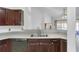 Kitchen featuring modern appliances, dark cabinets and light countertops with a double sink at 3137 Timucua Cir, Orlando, FL 32837