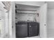 Well-organized laundry closet with shelving, washer, and dryer at 3137 Timucua Cir, Orlando, FL 32837