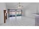 Open living room with tile floors and sliding glass doors leading to the outdoor pool area at 3137 Timucua Cir, Orlando, FL 32837