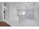 Bright living room featuring white tile floors, neutral walls, and a decorative half wall for added character at 3137 Timucua Cir, Orlando, FL 32837