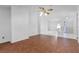 Open-concept living space with a mix of wood laminate and tile flooring, seamlessly connecting multiple areas at 3137 Timucua Cir, Orlando, FL 32837