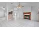 Spacious living room with a fireplace, tile floors, and an open layout to the kitchen at 3137 Timucua Cir, Orlando, FL 32837