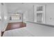 Spacious room with a mix of tile and wood laminate flooring, enhanced by natural light from the window at 3137 Timucua Cir, Orlando, FL 32837