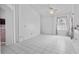 Bright room with white tile floors, neutral walls, ceiling fan, and a view into an adjacent room at 3137 Timucua Cir, Orlando, FL 32837