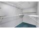 Empty walk-in closet featuring wire shelving and teal carpet at 3137 Timucua Cir, Orlando, FL 32837