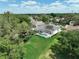 Aerial view of a home with large, green backyard and enclosed pool area at 3534 Woodley Park Pl, Oviedo, FL 32765