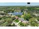Wide aerial shot featuring the lake with a fountain, surrounding houses, and the UCF stadium in the distance at 3534 Woodley Park Pl, Oviedo, FL 32765