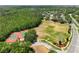 Aerial view featuring tennis courts and sports complex in lush, green community at 3534 Woodley Park Pl, Oviedo, FL 32765